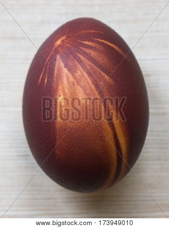 Easter red egg with amazing picture on wooden background