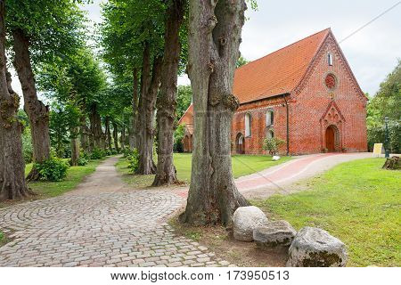 Haseldorf Germany-June 24 2011:Church of St. Gabriel. Church of the thirteenth century built of red brick and the alley in the old Park