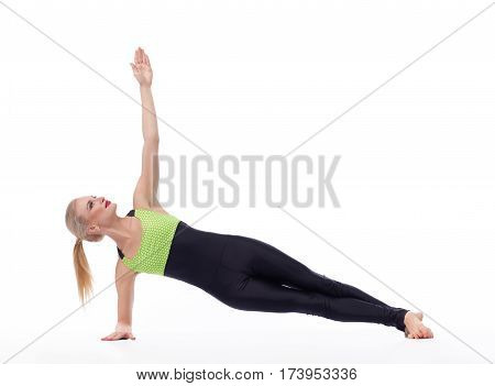 Perfect home workout. Attractive young active female doing yoga asana exercising in studio isolated on white copyspace yoga balance harmony strength fitness concept