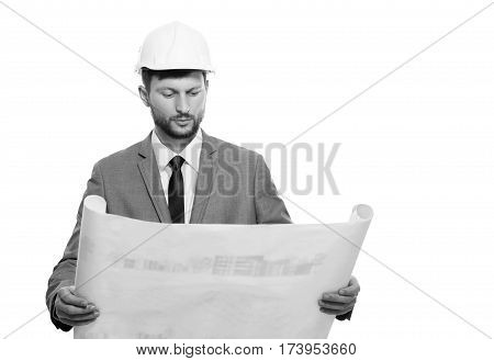 He is a planner. Professional male engineer studying a blueprint isolated on white copyspace monochrome shot professionalism experience architects builder engineering checking business concept
