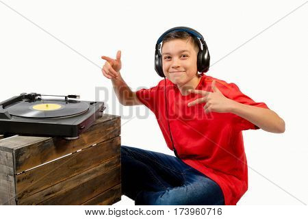 Teenage boy listening to a LP with headphones