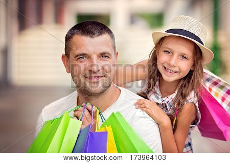 Happy father with daughter have a successful day of shopping
