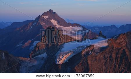 Sunset scene in the Swiss Alps purple mountains Fleckistock and Stucklistock.
