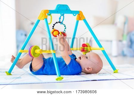 Baby Boy On Play Mat. Child Playing In Gym.