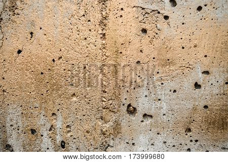 Concrete wall painted golden color. Structure background