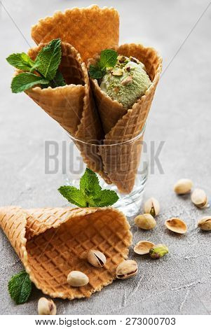 Pistachio Ice Cream And Mint With Pistachio Nuts On A Stonebackground