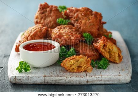 Crispy Onion Bhajis With Sweet Chilli Sauce On White Wooden Board