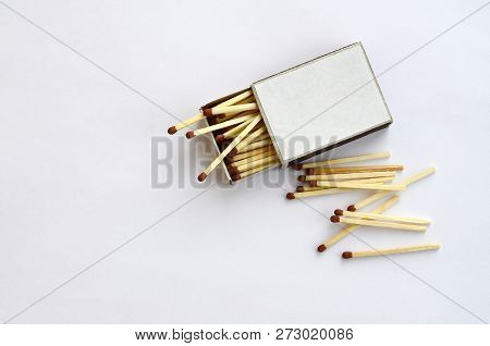 Open Cardboard Matchbox Filled With Matches On A White Background