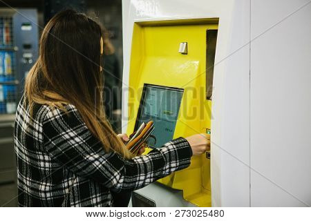 The Girl Buys A Ticket On The Subway In A Special Ticket Machine In Berlin In Germany.