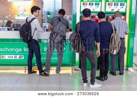 Bangkok, Thailand - 21 July 2018 - Asian Men Wait In Line Patiently To Use The Atm Mahine At Suvanna