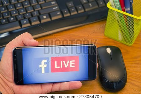 Piatra Neamt, Romania - July 30, 2018: Hand Holds A Samsung S8+ With Facebook Live Logo On The Scree