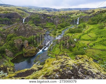 Beautiful Valley Gjain With Colorful Lava Rocks, Lush Green Moss And Vegetation And Blue Water With 