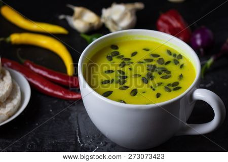 Pumpkin Asian Coconat Cream Soup. Autumn Hot Food. Chili Pepper, Garlic, Red Onion, Big Pumpkin. Dar