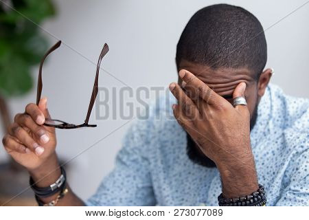 Employee Taking Off Glasses Touching Massaging Eyes
