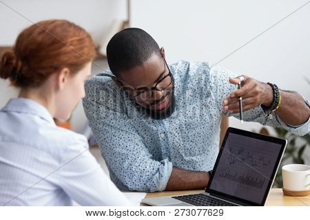 Colleagues Working Together Analyzing Data Looking At Laptop Scr