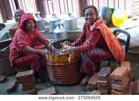 Bhaktapur, Nepal - January 23, 2017: Nepalese Women Working Hard In Building After The Earthquake Da