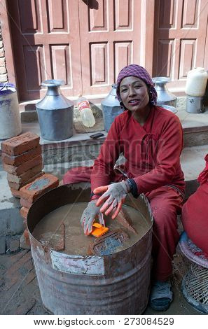 Bhaktapur, Nepal - January 23, 2017: Nepalese Woman Washing Bricks In Building Site After The Earthq