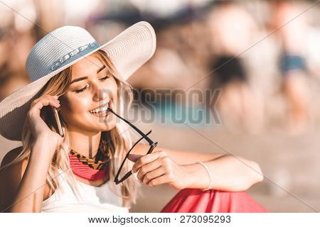 Attractive Girl Talking On A Mobile Phone On The Beach