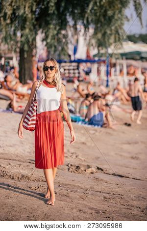 Pretty Young Woman With Bag On The Beach