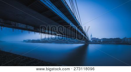 Bratislava Skyline With Bridge Over Danube River In Blue Tones