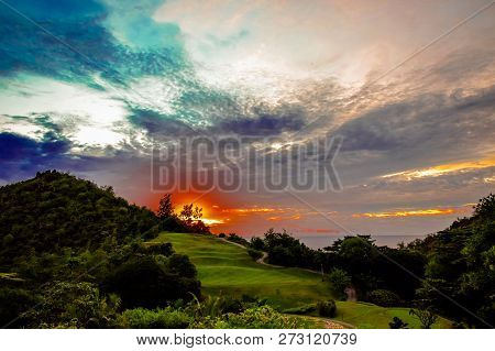 Sunset At Island Praslin, Seyshels. Green Hills And Blue Sky Whith Orange Sun