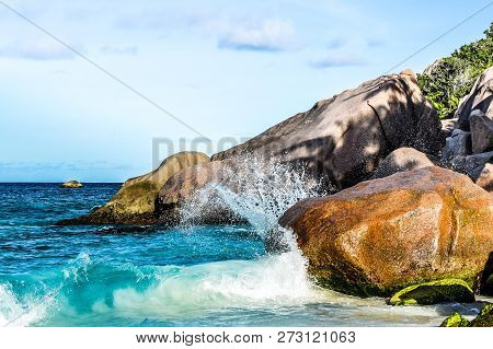 Wave Breaks Against Stone With Splash. Seychelles.