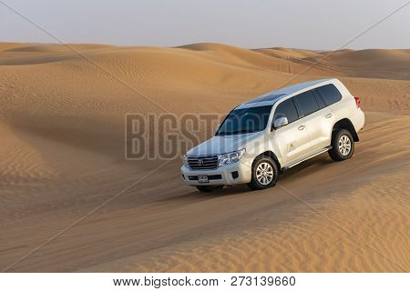Dubai, Uae - Oct 10, 2018: Toyota Landcruiser 4wd Driving Through Dunes, Also Called Dune Bashing As