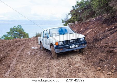 White Isuzu Car On The Hill, Dirty Way. Urban View. Travel Photo 2018, December.