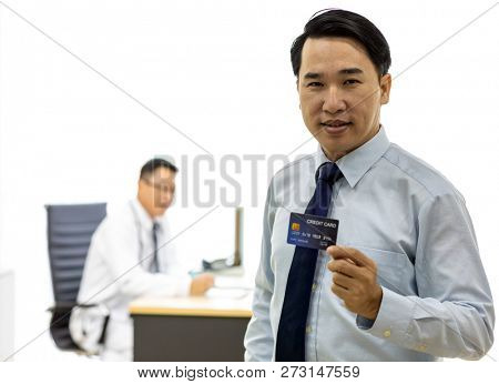 Portrait of Young adult Patient with credit card with examination room medical office background for insurance concept