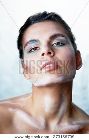 Creative Person. Makeup With Paint Strokes. Throws His Head Back.the Background Is Silver.