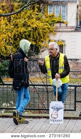 Strasbourg, France - Dec 8, 2018: Man With Emmanuel Macron Palcard And Text Wanted Talking With Pede