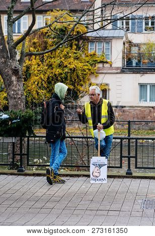 Strasbourg, France - Dec 8, 2018: Man With Emmanuel Macron Palcard And Text Wanted Talking With Pede
