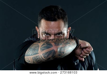 Tattooed Elbow Hide Male Face. Tattoo Culture Concept. Man Brutal Unshaven Hispanic Appearance Tatto