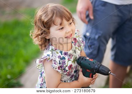 Cute Little Girl With Father's Drill, Outdoors