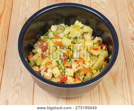 Chopped And Braised Various Vegetables In Inner Pot Of Household Electric Multi-cooker On A Wooden R