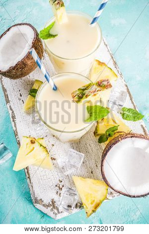 Refreshing Summer Drink, Homemade Pina Colada Cocktail, On A Light Blue Background, With Pieces Of P