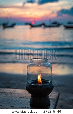 A Lit Glass Lantern On A Beach At Sunset In Ko Tao Thailand