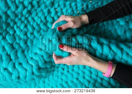 Girl Holding A Blanket Of Merino Wool Knitted Blanket, Close-up.