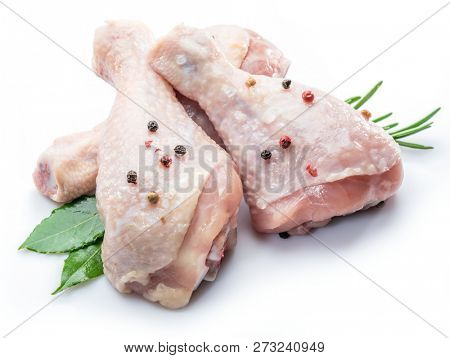 Chicken legs with spices isolated on white background.