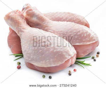 Chicken legs with spices isolated on white background.