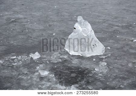 Block of ice extractad making a hole on a frozen lake. Hole frozen again.