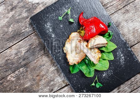 Chicken Breast Stuffed With Cheese And Ham With Spinach And Sweet Pepper On Stone Slate Background O