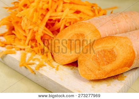 Fresh Carrot Grated On A Metal Kitchen Grate. Vegetables Prepared For Salad With A Meal On The Kitch