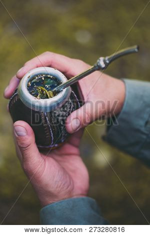 Man Holding Yerba Mate In Nature. Travel And Adventure Concept. Latin American Drink Yerba Mate