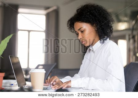Serious African American Woman Working With Documents At Workpla