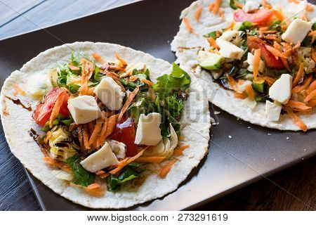 Homemade Vegetarian Tostadas With Salad, Cheese And Grated Carrot Slices