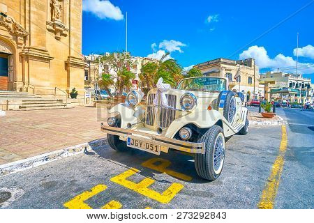 Naxxar, Malta - June 14, 2018: The Beautiful Vintage Wedding Car Decorated With Ceremonial Ribbons A