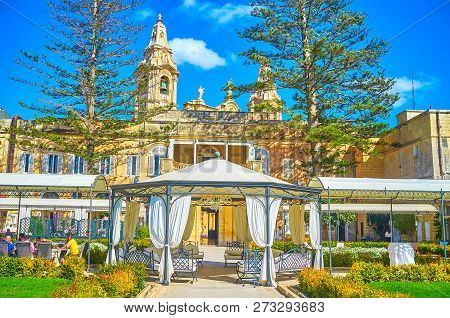 Naxxar, Malta - June 14, 2018: Visitors Of Palazzo Parisio Could Spend Their Time In Its Luxury Rest