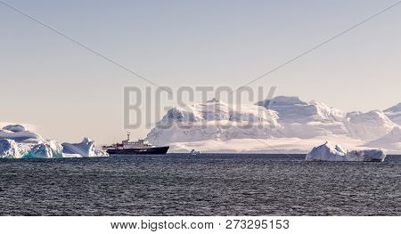 Touristic Cruise Liner Among Blue Icebergs Close To Cuverville Island, Antarctic