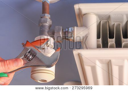Hand Of A Man, Repairman, Installation Radiator Valve Closeup
